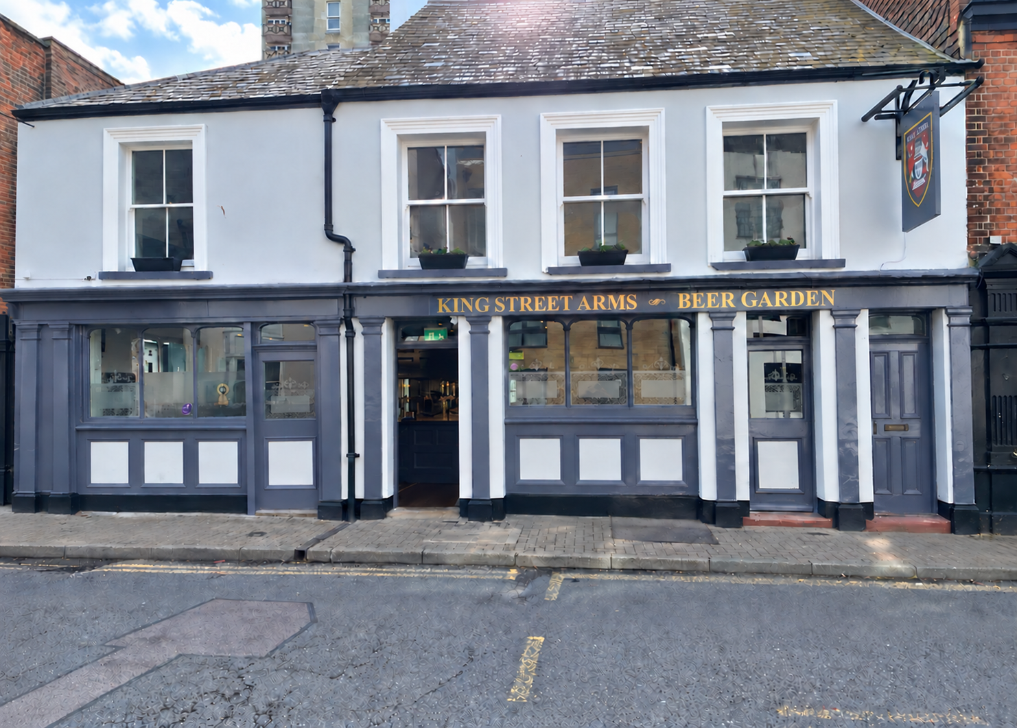 The King Street Arms pub frontage, with its slate-blue paintwork and gold lettering